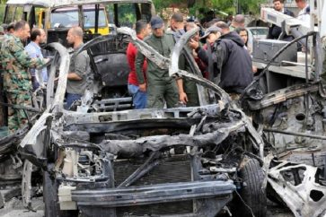 Syrians surround a the wreckage of a car following an explosion in Damascus on May 9, 2018.
A shelling and a car bomb blast in Syria's capital Damascus killed two people and wounded several others today, state television said. It reported "two killed and 14 wounded in terrorist attacks on Damascus Tower and Maysat Square". The shell struck at the tower in the central Marjeh Square district while the car bomb went off in the northeast of the city.
/ AFP PHOTO / LOUAI BESHARA