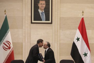 Syrian Prime Minister Imad Khamis (R) and Iranian Vice President Eshaq Jahangiri shake hands after the signing of an agreement event in the capital Damascus on January 28, 2019. (Photo by LOUAI BESHARA / AFP)