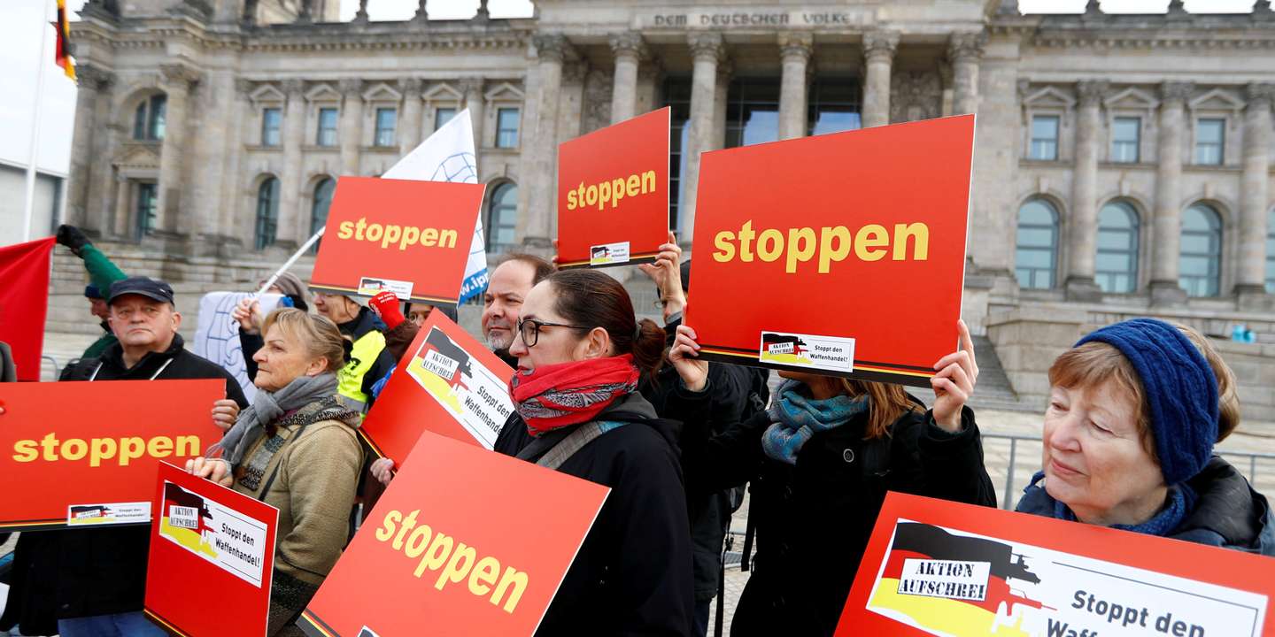 FILE PHOTO: Activists demand the government end worldwide weapons exports during a demonstration in front of Germany's lower house of parliament in Berlin, Germany, February 26, 2019. The words on the banner read "Stop." REUTERS/Fabrizio Bensch/File Photo