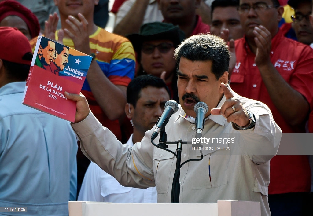 Venezuela's President Nicolas Maduro holds the government's plan for 2025, during a rally at the Miraflores Palace in Caracas, Venezuela on April 6, 2019. - Venezuela's opposition leader Juan Guaido urged his supporters to demonstrate to maintain pressure on Maduro, amid rising anger over the collapse of public services. Pro-Guaido protests drew thousands in rallies across the country, while a pro-Maduro counter-demonstration in Caracas drew thousands of people who marched toward the Miraflores presidential palace. (Photo by Federico Parra / AFP) (Photo credit should read FEDERICO PARRA/AFP/Getty Images)