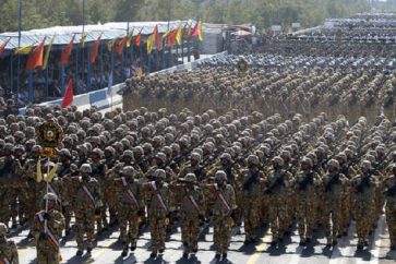 Iranian soldiers march during an annual military parade which marks Iran's eight-year war with Iraq, in the capital Tehran, on September 21, 2012.  Iran proudly paraded its military hardware in Tehran under the gaze of President Mahmoud Ahmadinejad, who used the event to again defiantly lash out at the West and Israel.   AFP PHOTO/ATTA KENARE        (Photo credit should read ATTA KENARE/AFP/GettyImages)