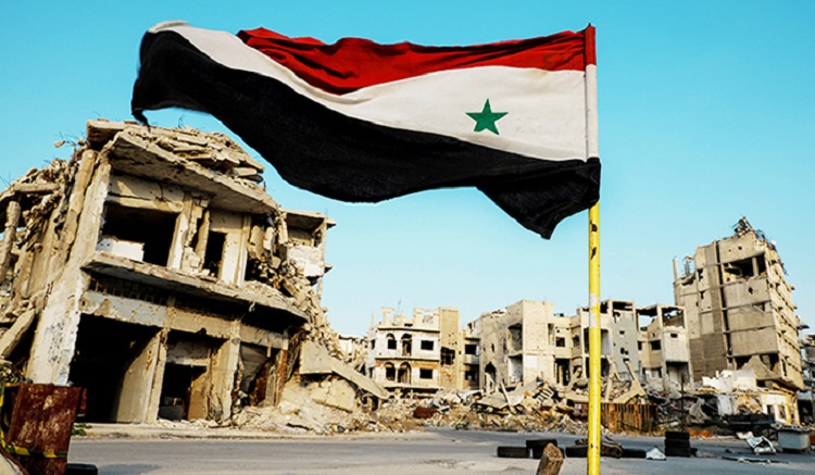 Syrian flag flutters at a military check point in al-Khalidiya area, in the government-controlled part of Homs, Syria, September 18, 2018. REUTERS/Marko Djurica