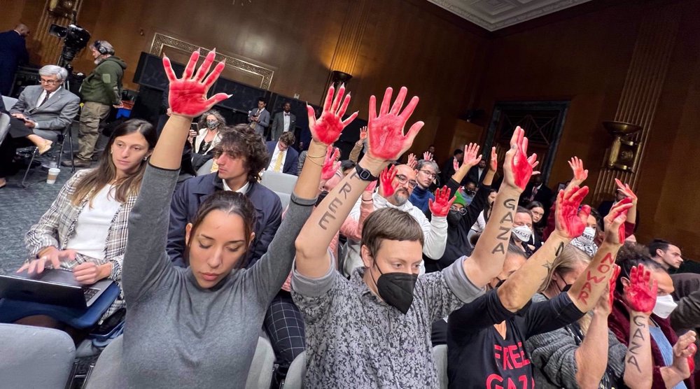 Des militants brandissent des mains avec de la peinture rouge en référence au meurtre des Palestiniens par Israël à Gaza avec le soutien de Washington, lors d'une audience au Sénat, le 31 octobre 2023. ©Reuters
